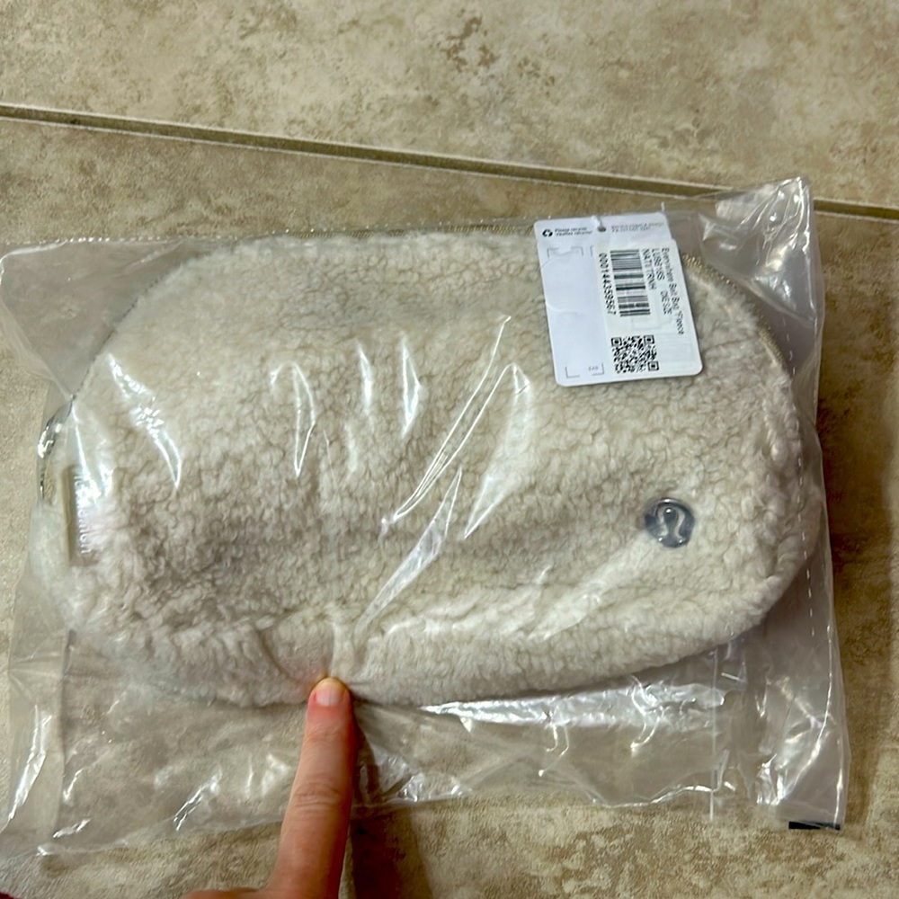 Lululemon everywhere belt bag in a winter white color and beige strap. Brand new